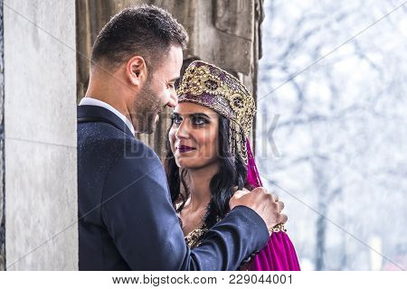 Happy Couple In Traditional Turkish Wedding Dress During Their Wedding In A Snow Storm