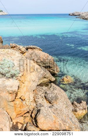 Rocks by the Mediterranean sea on the island of Ibiza in Spain, holiday and summer scene