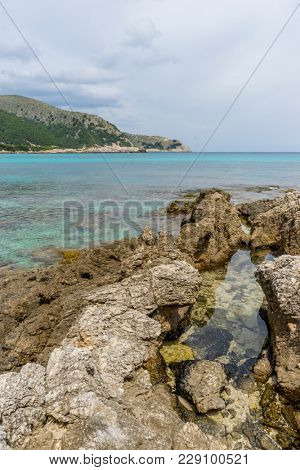 Rocks by the Mediterranean sea on the island of Ibiza in Spain, holiday and summer scene
