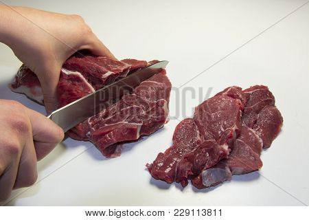 Woman Cutting Raw Equino Meat, Equino Steak
