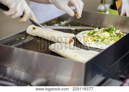 Close-up Of Hands Of Cook In Gloves Preparing Fajitas Or Fajitos. Healthy Fresh Tortillas With Grill