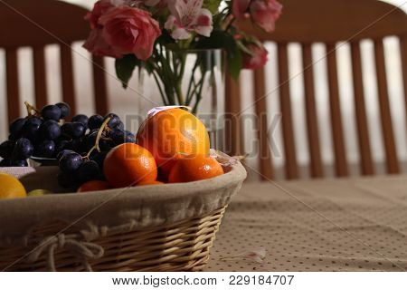 Fruit In A Basket On The Table With Flower