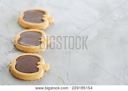 Sweet Apple Shaped Cookies Arranged In Rows On Light Textured Background, Close-up, Shallow Depth Of