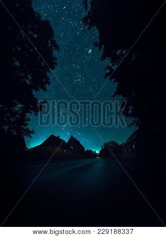Night City Street Is Calm And Quiet And Night Sky Full With Stras On Background