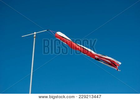 Weather Vane In The Blue And Clear Sky