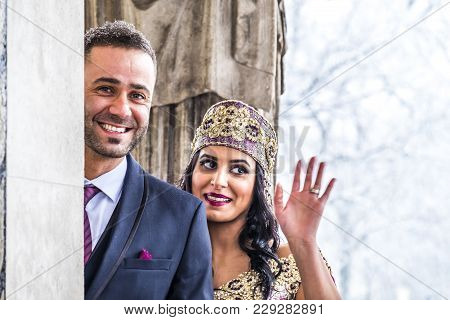 Happy Couple In Traditional Turkish Wedding Dress During Their Wedding In A Snow Storm