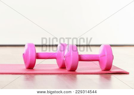 Dumbbells Lying On Matress. Training Gear On Floor. Fitness Health Workout Concept.