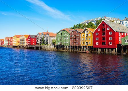 Colorful Old Houses At The Nidelva River Embankment In The Center Of Trondheim Old Town, Norway