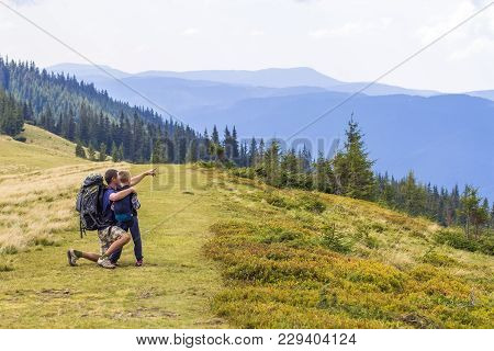 Father And Child Hiking In Scenic Mountains. Dad And Son Enjoying The View From The Mountain Top In 