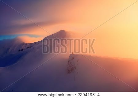 High In The Mountains The Sun Is Rising And Enlightens Everything With Wonderful Color. The Mountain