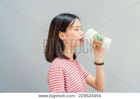 Bangkok, Thailand - March 05, 2018 : Woman Drinking Starbucks Coffee On The Chair, Starbucks Brand I