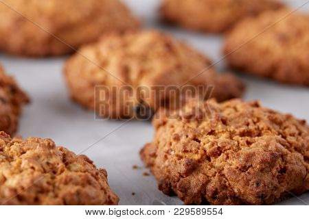 Sweet Cookies With Raisin Arranged In Pile On Light Textured Background, Close-up, Shallow Depth Of 