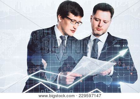Handsome European Businessme Examining Contract Together On Abstract Forex Background. Finance And T