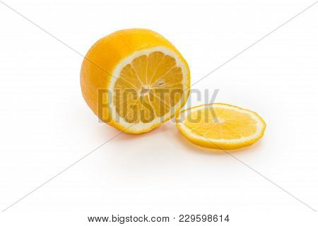 Half And One Thin Slice Of The Meyer Lemon On A White Background