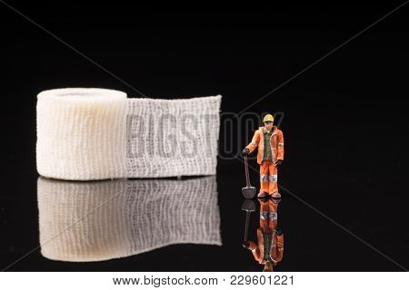 Bandage Used For Injuries During Work, Leisure Time Or In Housework, Isolated On Glossy Black Backgr