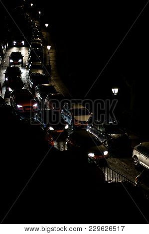 Many Cars Driving In A Line In Narrow Streets Of Big Cities