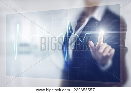 Business Women Toching The Pulse Screen In The Hospital