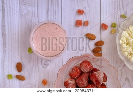 Strawberry Cocktail In A Glass On A White Wooden Table