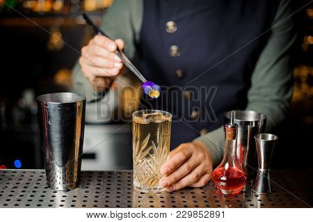 Barman Serving An Adorable Fresh Alcoholic Red Cocktail With An Cooled Ice On The Steel Gray Barstan