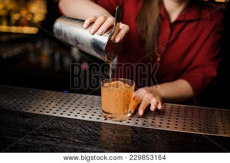 Barman Serving An Adorable Fresh Alcoholic Red Cocktail With An Cooled Ice On The Steel Gray Barstan