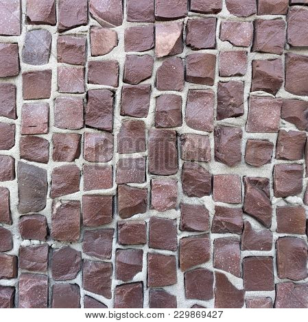 Brown Smalt Tiles On Gray Cement Wall.