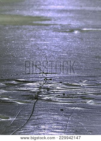 Sparkling Shards Of Cracked Ice Jut Out On The Frozen Lake. The Light Effect Occurs In Deep And Shal
