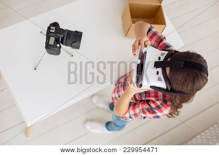 Helping The Inexperienced. The Top View Of A Petite Pre-teen Girl Showing How To Use A Vr Headset Co