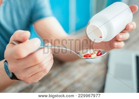I Need It. Helpful Expensive Vitamins Being In The Spoon Which Man Holding.