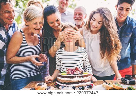 Family Celebration Outside In The Backyard.big Garden Party. Birthday Party. Small Girl With A Birth