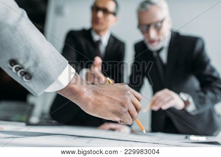 Partial View Of Multicultural Businessmen At Meeting In Office