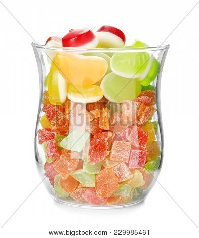 Glass jar with colorful jelly candies and  succades on white background