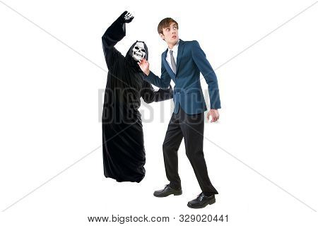 Man In A Halloween Grim Reaper Ghost Costume Chasing, Mocking And Making Fun Of Scared Businessman R