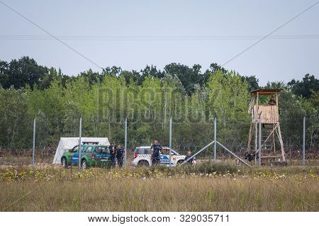 Kelebija, Serbia - September 10, 2016: Hungarian Policemen Watching The Serbian Hungarian Border Fen