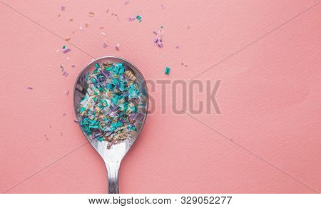 Environmental Pollution And Water Microplastic. Micro Plastic With Spoon