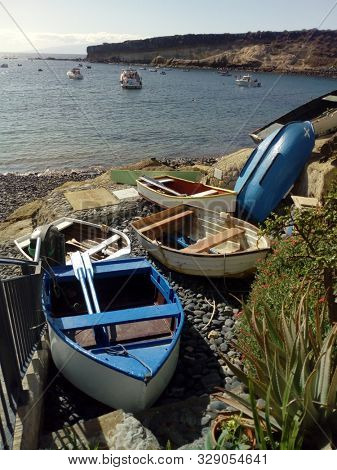 EL PUERTITO/ TENERIFE- 12th October 2019: Colourful rowing boats, in the foreground of el puertito bay, which is famous for its clear blue waters.