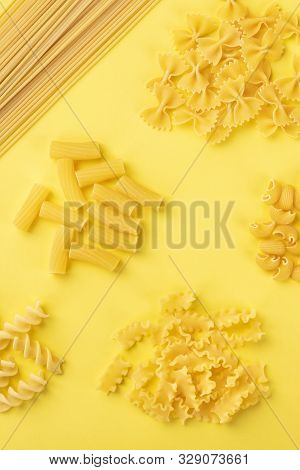 Italian Pasta Variety, Shot From The Top On A Yellow Background, A Flat Lay Banner