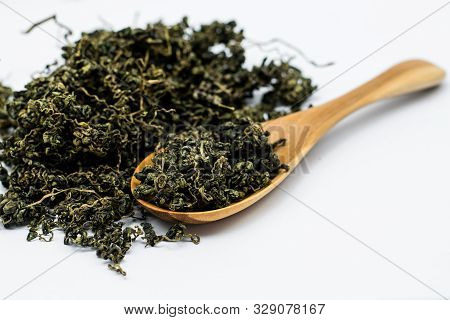 Dry Gynostemma Pentaphyllum Leaf With Wooden Spoon On White Blackground