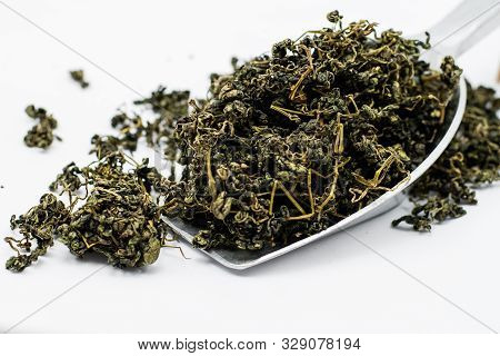 Dry Gynostemma Pentaphyllum Leaf With Metal Scoop On White Blackground