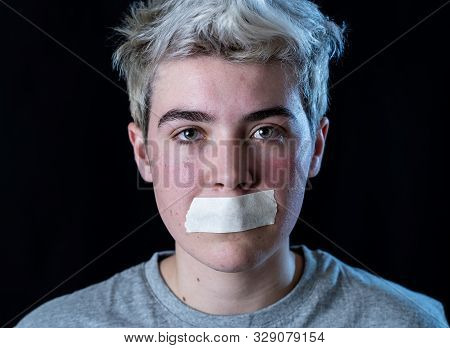 Conceptual Image Of Censorship And Social Tabu. Transgender Teenager With Mouth Sealed