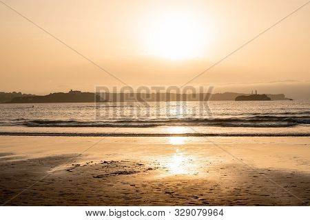 Spanish Destination On Atlantic Ocean, Somo Beach In Cantabria Region, View On Lighthouses At Sunset