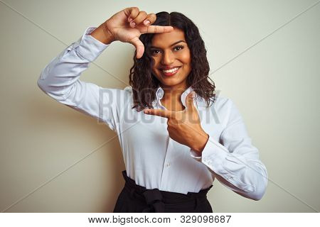 Beautiful transsexual transgender elegant businesswoman over isolated white background smiling making frame with hands and fingers with happy face. Creativity and photography concept.