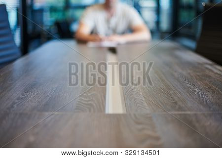 Employee In Office Conference Room. Manager At Table In Modern Meeting Room For Business Negotiation