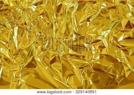 Gold Foil Leaf Shiny Texture, Abstract Yellow Wrapping Paper For Background And Design Art Work.