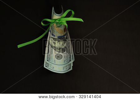 Four Banknotes Four Hundred Us Dollars On A Black Background Tied With A Green Ribbon