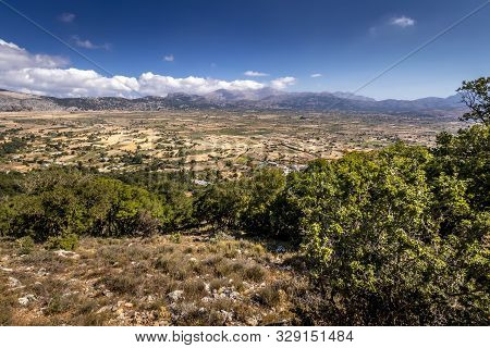 Top View Of The Lassithi Plateau On A Sunny Day With Cloudy Sky.