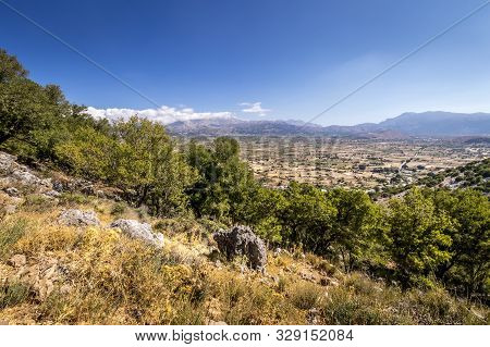 Top View Of The Lassithi Plateau On A Sunny Day With Cloudy Sky.