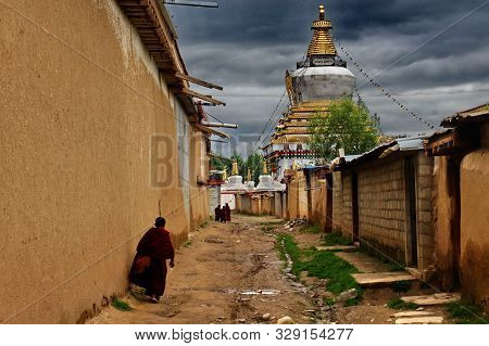 A Little Lama Of Laprang Temple In Gannan, Qinghai Province Returns Home From His Class.