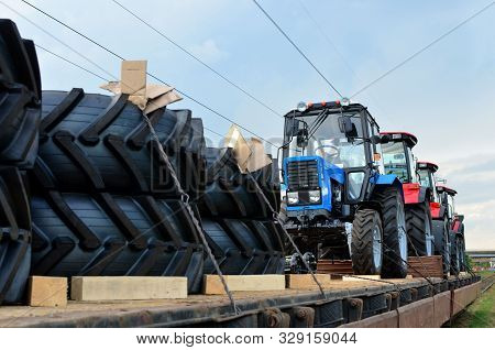 Farm Tractors Loaded On A Freight Train. Import/export Of The Agriculture And Farming Equipment. Log
