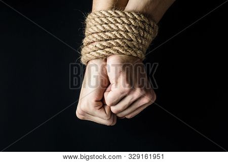 Hands Tied With A Rope On A Black Background, The Concept Of Stealing People, Right Day