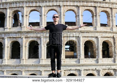 Male Tourist Standing Near Coloseum In Background In Rome, Italy.